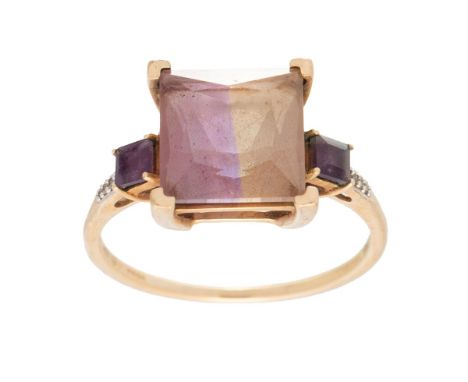 A 9ct gold, tourmaline, amethyst and diamond dress ring, the large emerald cut tourmaline with distinct variation of tone fro