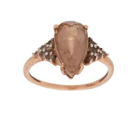 A 9ct gold and quartz dress ring set with central pear cut smokey quartz with white stone highlights to the shoulders, fully 
