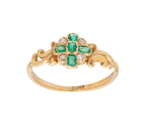 An 18ct gold, diamond and emerald dress ring, with central quatrefoil of five diamonds interspersed with four old cut diamond