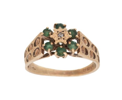 A vintage 9ct gold emerald and diamond flowerhead ring in the Brutalist style, set with six emerald petals surrounding an ill