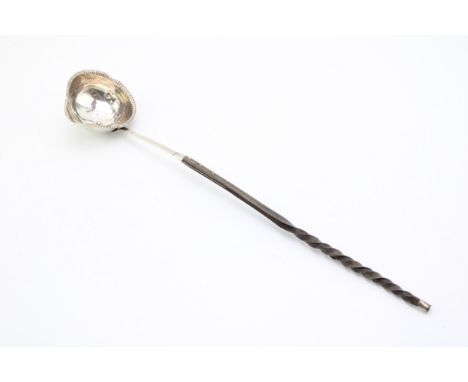 A George III silver toddy ladle with baleen twist handle, the bowl with beaded rim and pouring spout, hallmarked to the stem,