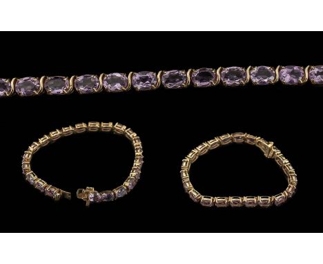Ladies 9ct Gold Amethyst Set Line Bracelet - Marked 9ct. well Matched Pale Amethysts of Pleasing Colour. Length 7'' (17.5 cm)