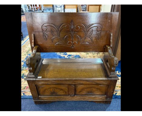 Two Seater Monks Bench with table top, carve supports and front panels.  Measures 40'' high x 39'' wide.