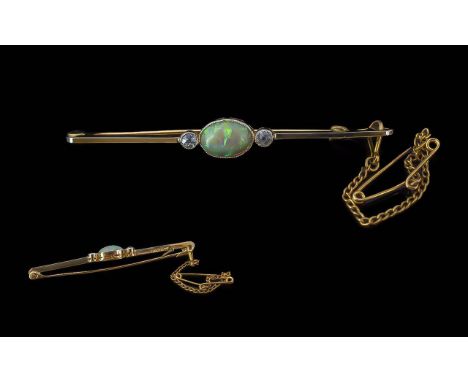 Ladies 18ct Gold and Platinum Opal and Diamond Set Stick Brooch. Marked 18ct and Platinum, Opal of Good Colour, Flanked by Tw