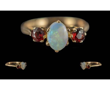 Ladies 9ct Gold 3 Stone Opal and Garnet Set Ring, Full Hallmark to Interior of Shank. The Central Opal of Excellent Colours, 