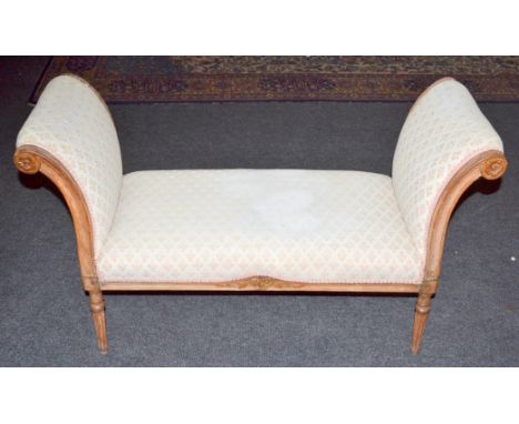 A Victorian carved walnut double scroll window seat on turned fluted legs upholstered in a cream and gilt tapestry design, le