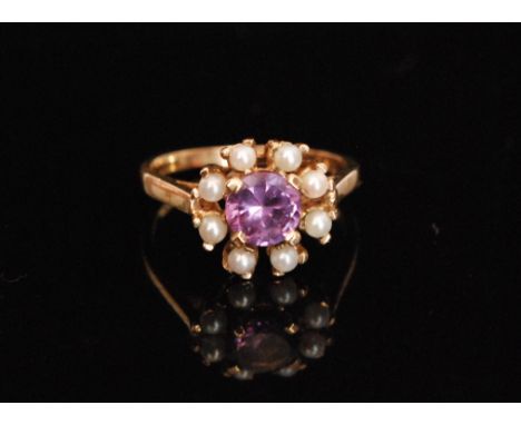 A 10ct synthetic alexandrite and seed pearl cluster ring, central alexandrite within eight stone pearl surround, ring size L.