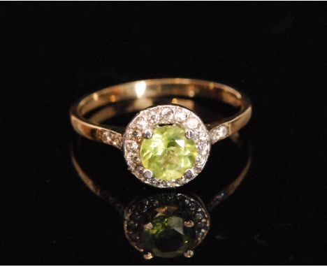 A 9ct hallmarked peridot and cubic zirconia ring, circular peridot within cz surround, all to stone set shoulders, ring size 