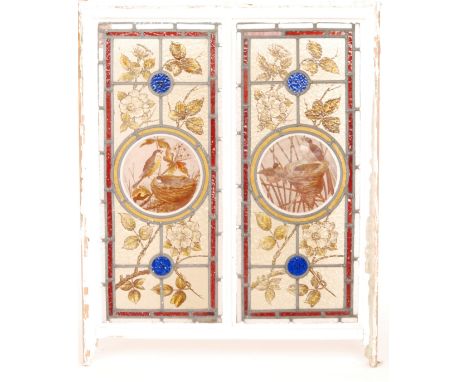 A pair of late 19th Century Aesthetic Movement twin panel leaded windows in painted pine frames, the central roundels detaile