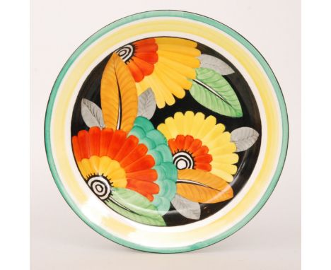A 1930s J&G Meakin Art Deco shallow charger decorated with brightly coloured flowers and foliage against a black ground, prin