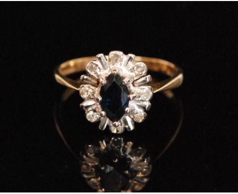 A 9ct hallmarked sapphire and diamond cluster ring, central oval sapphire within an eight stone diamond surround, ring size M