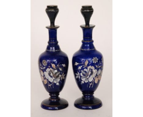 A pair of late 19th Century Continental bottles of footed ovoid form with collar necks and stoppers, cased in deep blue over 