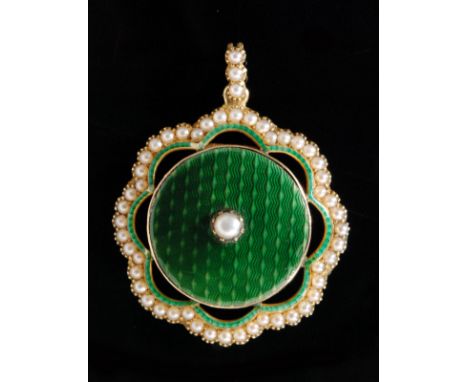 An Edwardian 15ct floral enamel and seed pearl pendant, the circular green guilloche enamel roundel centred by a claw set see