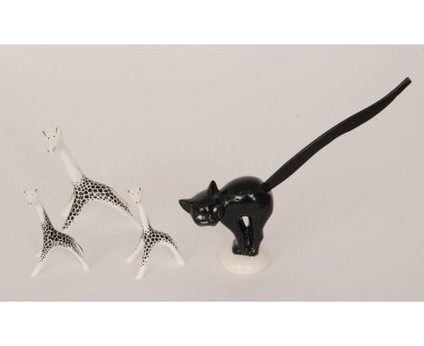 A 1930s Goebel Pretzel holder modelled as a black cat with arched back and long wooden tail together with three Cmielów styli