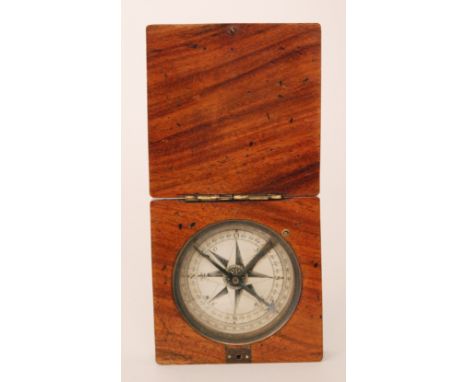 A mid 19th Century pocket of travelling compass the dial enclosed by a hinged cover, width 8cm.