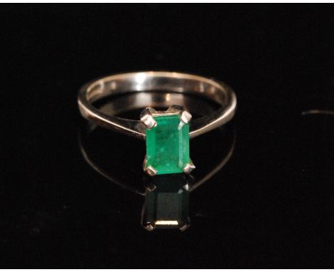 A modern 9ct white gold emerald ring, the rectangular step cut emerald, approx 0.75ct, claw set to knife edge shoulders, weig