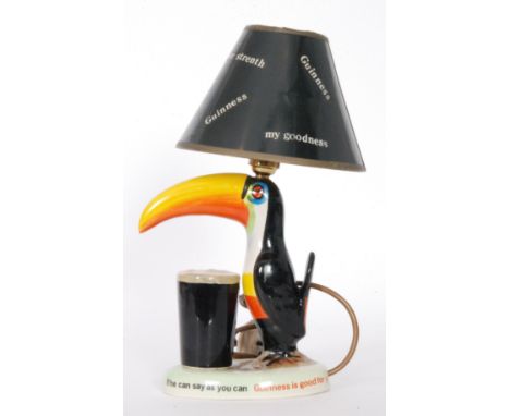 A Guinness style Toucan lamp and shade, height 22cm