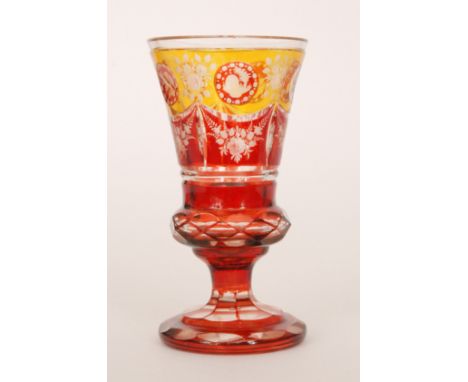A late 19th Century Bohemian goblet of footed thistle form, enamel decorated in golden amber and ruby and flash cut and engra