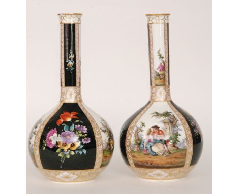 A pair of late 19th to early 20th Century bottle vases panel decorated with sprays of flowers against a black ground flanked 