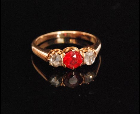 A 15ct diamond and ruby three stone ring, central old cut ruby flanked by two old cut diamonds, all to plain tapering band, w