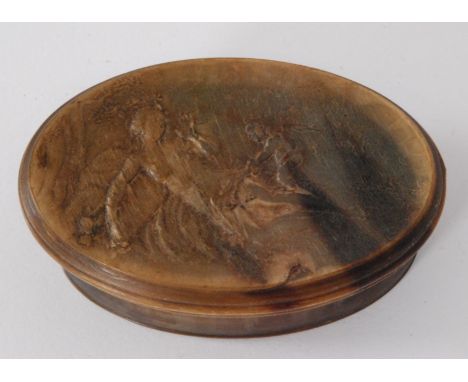 A 19th Century oval horn snuff box the pressed lid depicting a reclining classical maiden and a cherub by a river, length 8cm
