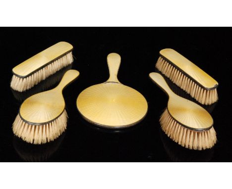 A 1930s hallmarked silver and guilloche enamel five piece dressing table set comprising of two hair brushes, a hand mirror an