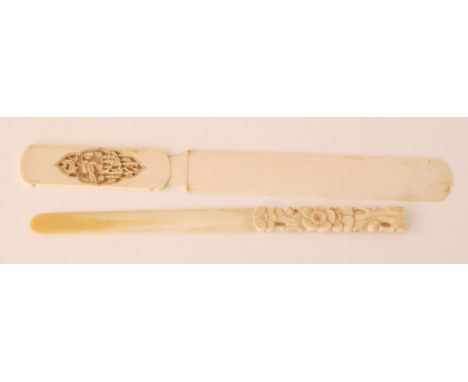 A late 19th Century Cantonese carved ivory page turner, the handle detailed with a recessed panel of figures under a weeping 