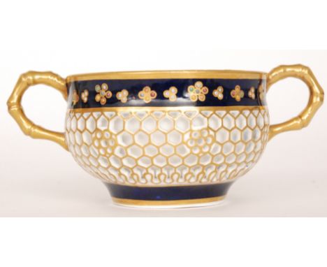 A 19th Century Chamberlain Worcester reticulated twin handled cup, the body with a honeycomb outer layer with gilt detailing 