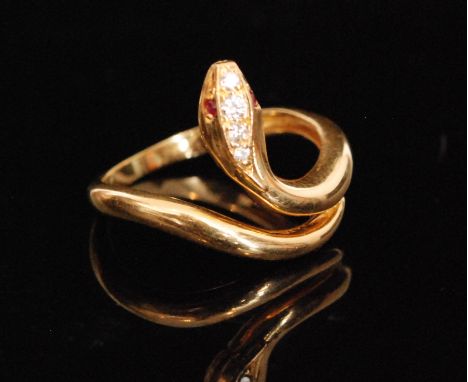 A modern 18ct hallmarked snake ring with diamond set head and ruby set eyes, ring size Q. 