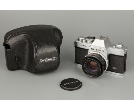 An Olympus FTL SLR Camera, with F.Zuiko Auto-S f/1.8 50mm lens, mirror stuck up, with cap and case