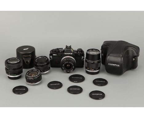 An Olympus OM-2 Spot/Program, together with Zuiko f/2.8 28mm, Zuiko Auto-Macro f/3.5 50mm, Zuiko f/2.8 24mm, Zuiko Auto-Zoom 