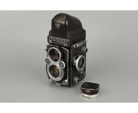 A Rollei Rolleiflex 3.5F TLR Camera, serial no. 2834027, with Carl Zeiss Planar f/3.5 75mm lens, with prism and lens hood