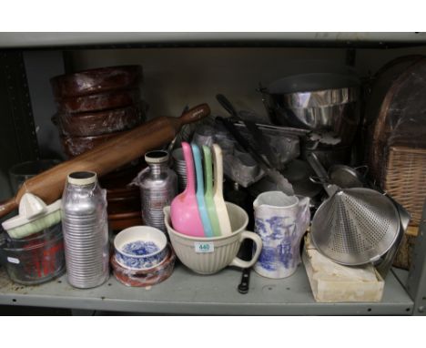 A large collection of kitchen equipment: terracotta pots, large wooden rolling pin, jugs etc. 