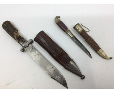 A Spanish made folding lock knife with 16cm Bowie type blade marked "Toledo". Stag horn grips. Overall length 26cm. Complete 