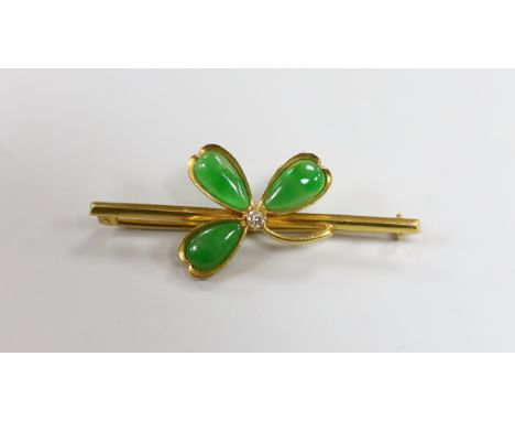 A Chinese yellow metal jade and diamond set petal bar brooch, 47mm, gross weight 4.9 grams, in fitted box.