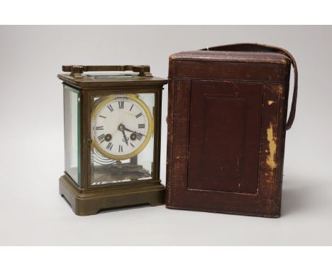 A large 19th century carriage clock with enamel dial and velvet lined leather case, the clock 19cm high