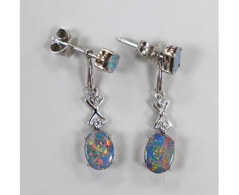 A modern pair of 585 white metal, two stone oval black opal doublet and two stone diamond chip set drop earrings, 25mm, gross