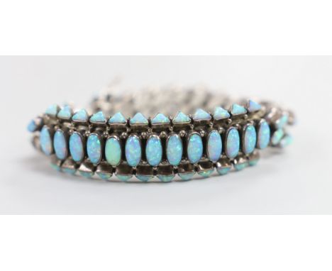 A large sterling and man made opal cluster set curb and arch link bracelet, gross weight 85.8 grams.