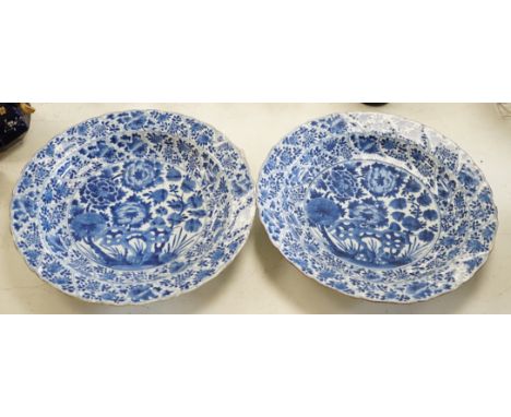 A pair of Chinese Kangxi blue and white dishes, painted with rock work and flowers, artemisia leaf marks, 37cm diameter