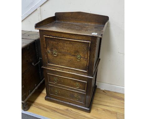 An 18th century oak wash stand, fitted with a cupboard, over a pull out base, with brass axe drop handles, width 59cm, depth 