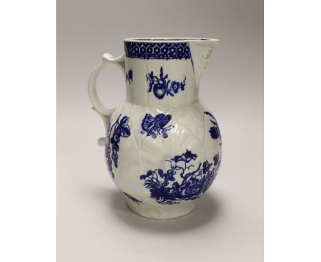 An 18th century Worcester fine mask jug decorated with the Parrot Pecking Fruit pattern, disguised numeral mark, 21cms high