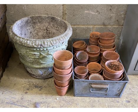 Approximately 45 assorted small terracotta pots and a circular reconstituted stone planter, diameter 37cm, height 32cm