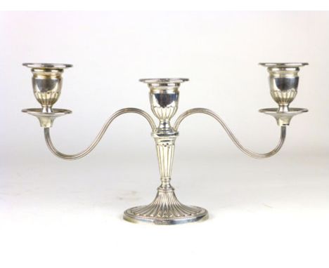 A modern silver two light, three branch candelabra of Neo classical form, makers mark JC Ltd, Birmingham, 1975 (weighted).