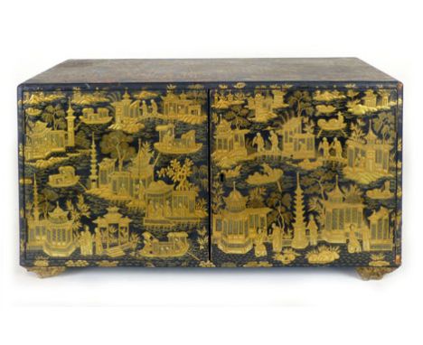 A Chinese black lacquered and tooled gilt decorated table cabinet, pair of doors enclosing a single shelf interior, the decor