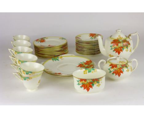 A Royal Doulton Art Deco style part tea set, decorated with  leaves and flowers in tones of orange and yellow, comprising cup