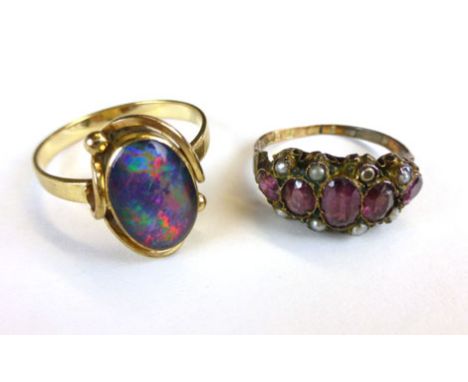 A yellow metal and opal set ring, possible a doublet, and another cluster ring (2)