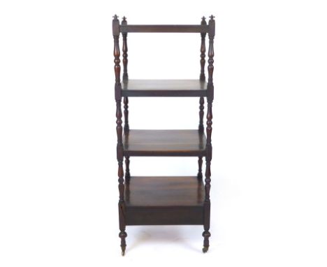 A Victorian Rosewood four tier what not, with turned shelf supports. h.120 cm. CONDITION REPORT: Some splitting to the woods,