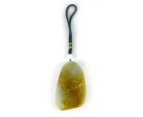A Chinese green jade type pebble, carved and gilded with landscape scenes, signature and red seal to reverse. h. 11 cm CONDIT