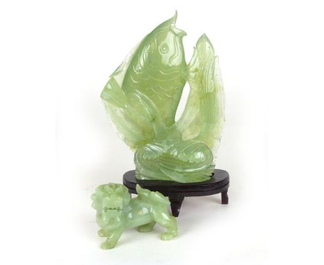 A Chinese green jade type stone carving of a leaping fish together with another of a dragon, on a stand. 19 cm and smaller (2