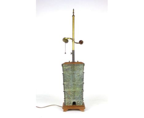 A Chinese archaic style bronze lamp of tapering rectangular section cast with various symbols to each side, total height excl